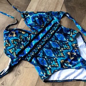 One piece blue and gold bathing suit. high cut, v neck, halter straps, p…